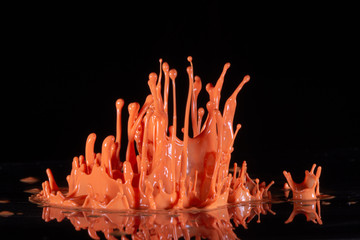 Poster - orange paint splash on a black background