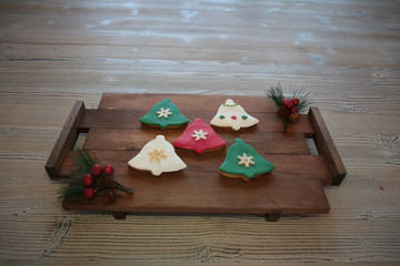 Plate with tasty Christmas cookies on wooden table