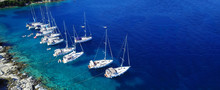 Aerial Drone Ultra Wide Photo Of Sail Boats Docked In Paradise Bay Of Fiskardo, Kefalonia Island, Ionian, Greece