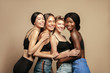 © Beauty Agent Studio - Multi Ethnic Group of Womans with diffrent types of skin standing together and looking on camera. Diverse ethnicity women - Caucasian, African and Asian against beige background