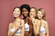 © Beauty Agent Studio - Overjoyed Multi Ethnic Group of Womans with diffrent types of skin standing together and looking on camera. Diverse ethnicity women - Caucasian, African and Asian against pink background