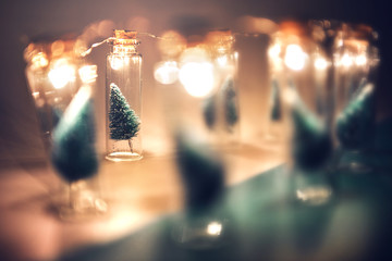 Wall Mural - close-up, elegant christmas tree in glass jar on green color background. copy space.