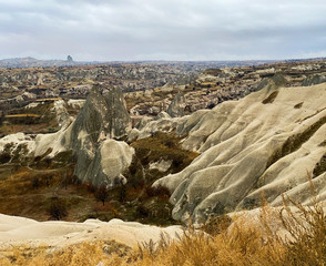 Wall Mural - Ancient rock formations with caves. A famous place for flying in balloons. Cappadocia. Turkey November 5, 2019.