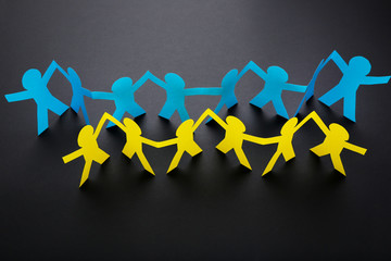 Wall Mural - Paper chain people on black background