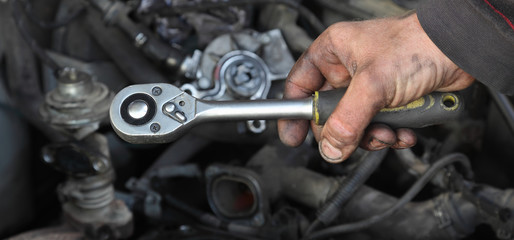 Wall Mural - Socket wrench tool in mechanic hand