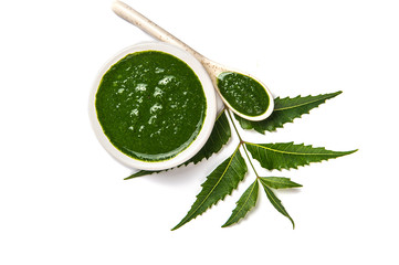 Wall Mural - Medicinal Neem leaves with neem paste in spoon and plate on white background (Azadirachta indica)