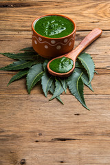 Wall Mural - Medicinal Neem leaves with paste on wooden background