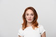 © atdigit - The face of a beautiful woman with red hair a little lower than the shoulders. In a light dress with short sleeves, she has a confident, friendly look in which determination and humility are manifeste