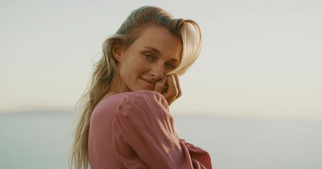 portrait of attractive woman smiling at sunset