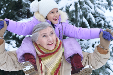 Canvas Print - Portrait of grandmother and granddaughter in winter