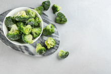 Frozen Broccoli Florets On Light Grey Table, Flat Lay. Vegetable Preservation