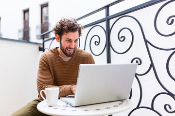 Wall Mural - Businessman working on computer, drinking coffee and smiling, business man entrepreneur working on computer, businessman reading emails and smiling