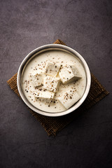 Wall Mural - Paneer Dum Kali Mirch / Kalimirch, prepared in a white creamy gravy and black pepper powder sprinkled over it. served in a bowl. Selective focus