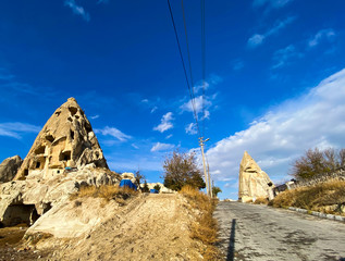 Wall Mural - Cone-shaped mountains. Caves in the valley of Cappadocia. Tourist place. November 5, 2019