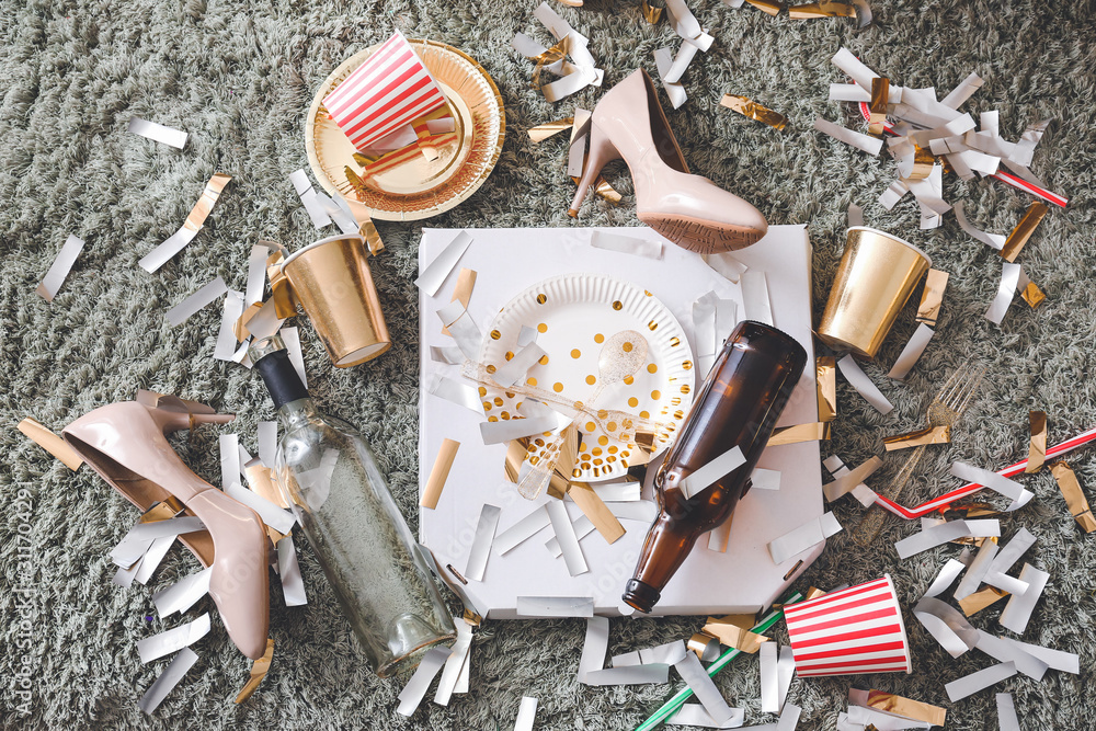 Floor with with terrible mess in room after New Year party