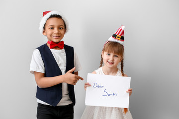 Sticker - Cute little children with letter to Santa Claus on white background