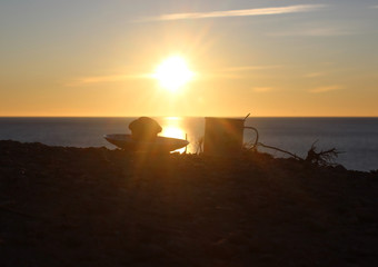 Muffin and a coffee cup during sunrise at the sea