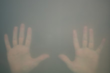 Hands Behind The Frosted Glass. Hands Silhouette In The Mist. Loneliness Concept. Palm Touches The Glass Window