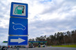 © Masarik - Road sign, pointed out to power station, with usual kinds of fuel and electric vehicle charging station (EV), on blue background.
