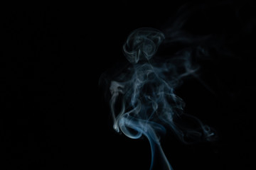 Beautiful abstract blue smoke with copy space on black background. Smoke background for art design or drawing. Abstract figure of the smoke