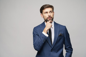 Studuo shot of thinking businessman wearing suit