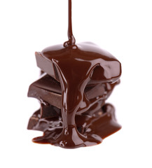 Wall Mural - Chocolate pieces stack and chocolate syrup isolated on white background. Close up.