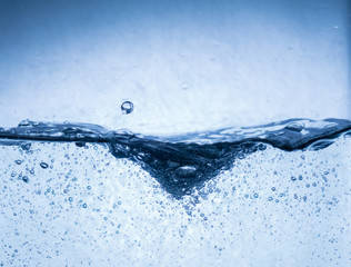 Water splash isolated on white. Close up of splash of water forming unique wave shape,