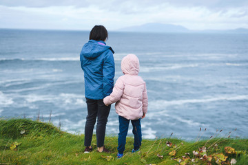 Wall Mural - mother and daughter looking at sea