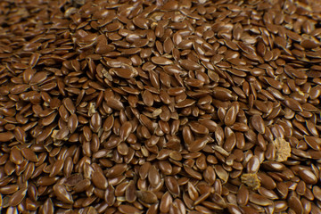 Poster - Linum usitatissimum is scientific name of Brown Flax seed. Also known as Linseed, Flaxseed and Common Flax. Closeup of grains, background.