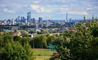 Skyline of Central London with the skyscrapers of the City of London, a financial district, and famous sights such as the Shard and St Paul's Cathedral, seen from Parliament Hill on Hampstead Heath