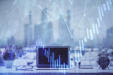 Forex graph hologram on table with computer background. Multi exposure. Concept of financial markets.