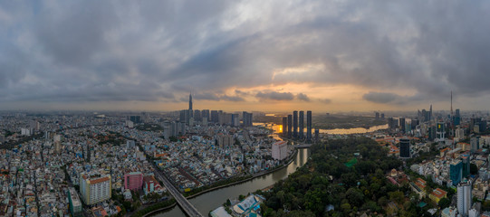 Wall Mural - Sunrise panorama of Ho Chi Minh City and Saigon River including all key buildings with beautiful sky