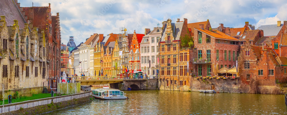 Ghent, Belgium old colorful traditional houses along the canal and boats, panoramic banner - obrazy, fototapety, plakaty 