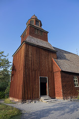 Wall Mural - Traditional architecture of old Swedish building in Skansen open air museum at Djurgarden island, historic recreational area. XVIII century wooden Seglora church. Stockholm, Sweden.