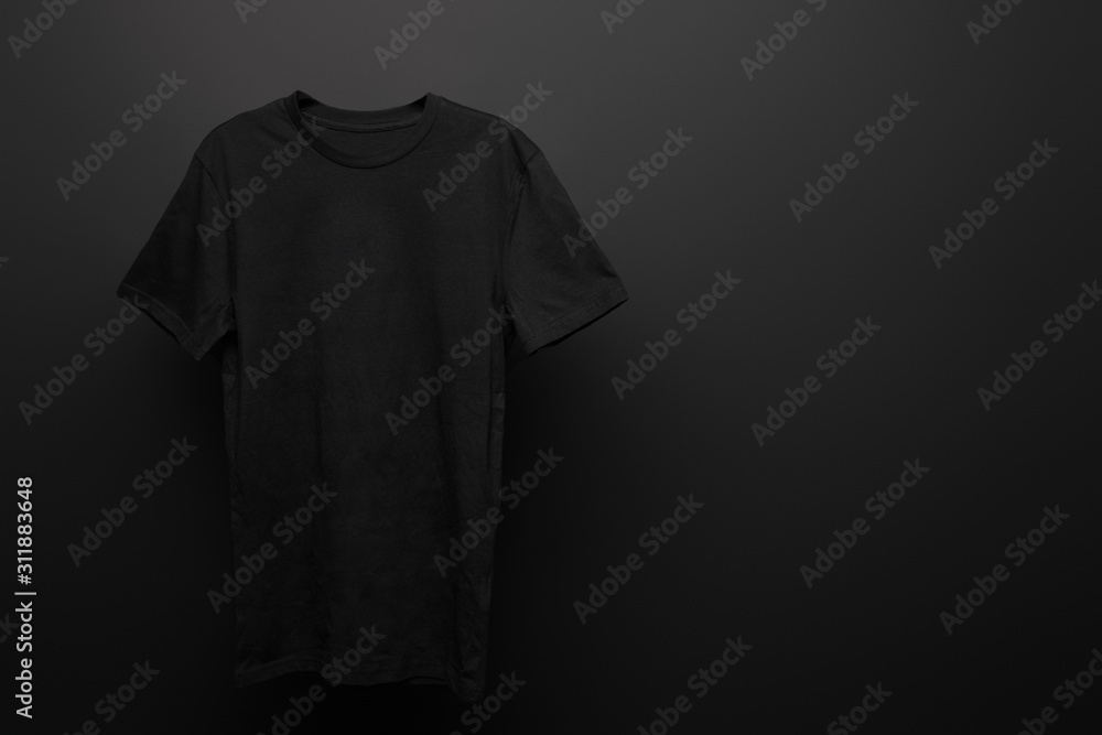 blank basic black t-shirt on black background - obrazy, fototapety, plakaty 