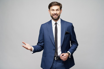 Portrait of a young businessman pointing on a copyspace with his finger