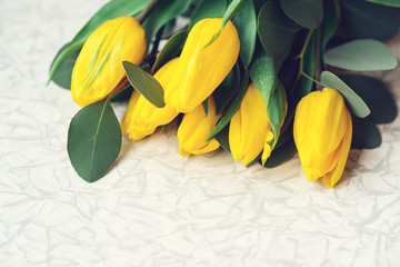 Wall Mural - Spring and presents. Easter card with yellow tulips and copy space. Spring mood. Beautiful spring flowers, top view