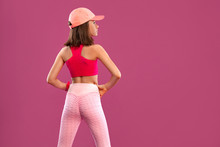 Fitness For Children. Kid Girl Doing Fitness Exercises On Green And Pink Background In Sportswear. Sports Concept.