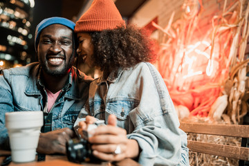 Wall Mural - Pretty Afro American lady near her boyfriend in street cafe