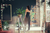 Fototapeta Londyn - Beautiful girl model dressed in black clothes in Loft style interior