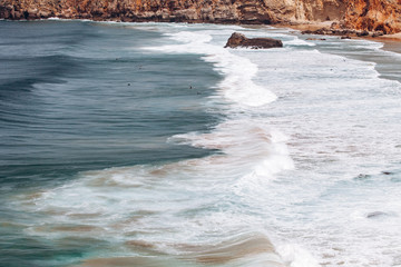 Wall Mural - Beautiful view of the sea waves from the rocks in algarve, Portugal