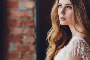 Wall Mural - The beautiful woman posing in a wedding dress.