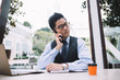 © GalakticDreamer - Asian businessman talking on phone at workplace