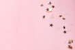 © KatrinaEra - Silver star confetti on pastel pink background. Bright and festive holiday background.