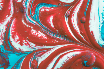 a colourful swirl of oil and red, white and blue water based acrylic and vinyl paints and inks blended together to create a unique abstract background