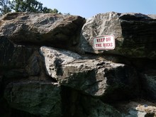 Keep Off The Rocks Sign On Boulders