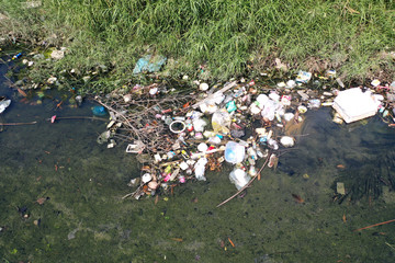 Canvas Print - Water pollution. Raw sewage and plastic trash dumped in stream in poor slum village 