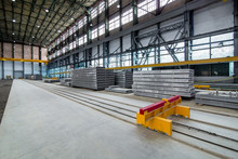A Plant For The Production Of Hollow Floor Slabs With Indoor Equipment And New Panels Piled On A Pile For The Construction Of Buildings.