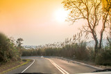 Fototapeta Zachód słońca - sunset on curve road in the mountain and forest, country road of Nan in north of Thailand
