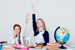 © dmitriisimakov - two girls in the school geography lesson study knowledge in the classroom